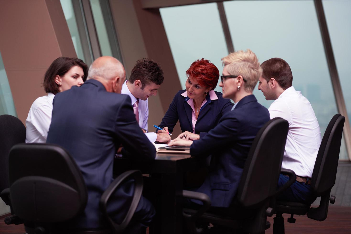 People reviewing documents together at a meeting
